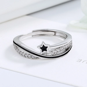 Minimalist silver star ring featuring black enamel and sparkling cubic zirconia stones