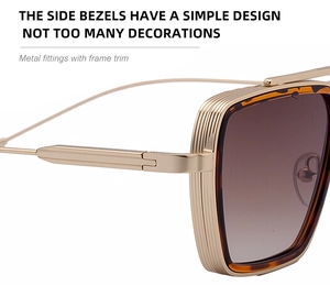 Detail view of square sunglasses with gold metal frame and gradient lenses