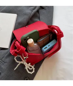 Internal view showing storage capacity of a red litchi pattern saddle bag for daily essentials