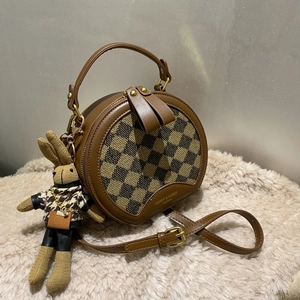 Brown semi-circle crossbody bag with checkered panel and cute rabbit doll charm