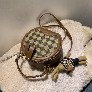 Stylish round crossbody bag with brown checkerboard pattern and a cute rabbit pendant