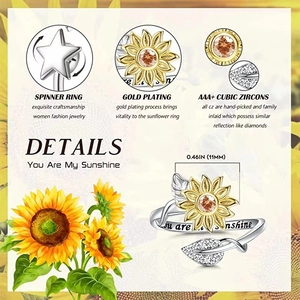 Detail of spinning sunflower ring with You are my sunshine engraving and gold plating