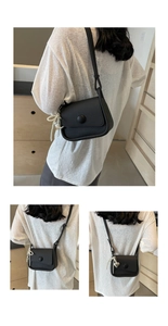 Detail of lychee pattern saddle bag with pearl chain and heart charm decoration