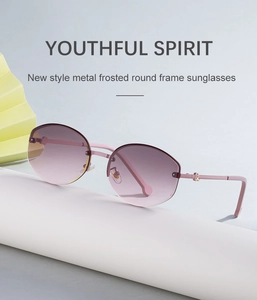 Macro shot of gradient pink rimless lenses with diamond-cut edges on metal sunglasses