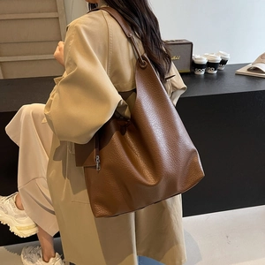 Large dark brown pebble leather tote bag with side zipper for work or travel