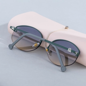 Detail of dark green rimless sunglasses with brown gradient lenses on pink stand