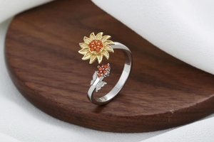 Macro detail of sunflower spinner ring with golden petals and amber zircon stones