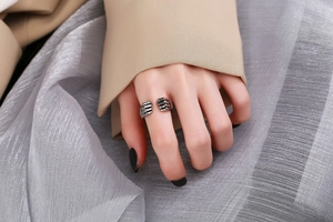 Macro shot of silver hip-hop fist ring showing vintage texture and adjustable open band