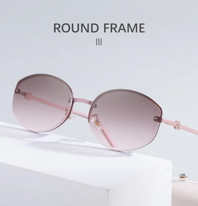 Detail of rimless pink gradient round sunglasses with slim pink metal temples and accents