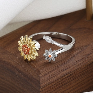 Adjustable sunflower spinner ring in silver and gold tones with orange gemstones