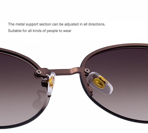 Macro shot of adjustable silicone nose pads and brown metal bridge on semi-rimless sunglasses