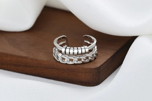 Close-up of rotatable beads and chain texture on a silver fidget ring for anxiety