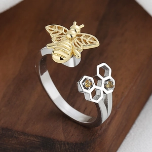 Niche honeycomb open ring with golden bee and inlaid yellow diamonds on silver band