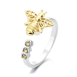 Adjustable silver honeycomb ring featuring a golden bee detail and yellow gemstones