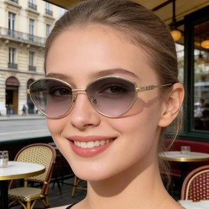 Dettaglio di occhiali da sole cat-eye con lenti sfumate viola e sottile montatura oro