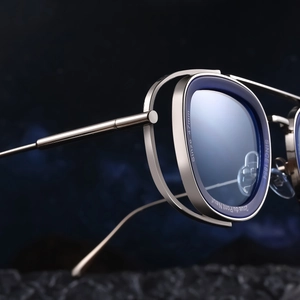 Macro view of silver metal sunglasses frame with intricate dual-layer textured edge engraving