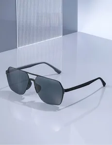 Detail of square frame aviator sunglasses with black metal frame and dark grey lenses