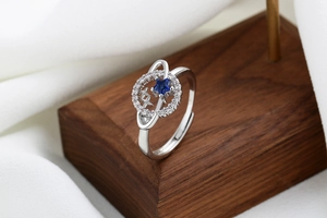 Macro view of silver star ring with a blue celestial stone and pavé crystal orbit