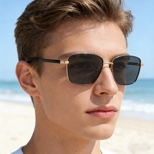Close-up of square polarized sunglasses featuring gold metal bridge and dark grey lenses