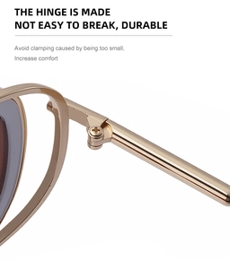Close-up of durable metal hinge on golden oval sunglasses with dark gray lenses