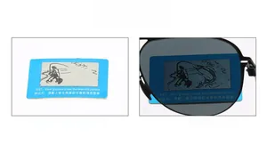 Polarized lens test card showing clear fishing scene visibility through the dark lens