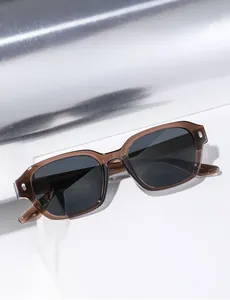 Detail view of small rectangular polarized sunglasses with translucent brown frames