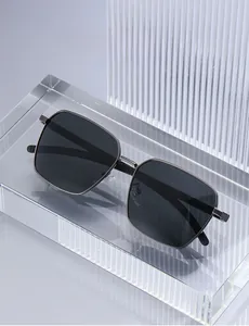 Detail of square polarized sunglasses with gunmetal frame and dark grey lenses on stand