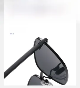 Detail of metal hinge and transparent nose pads on black polarized square sunglasses