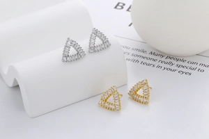 Detailed view of triangular hollow stud earrings with micro-pave rectangular zircons