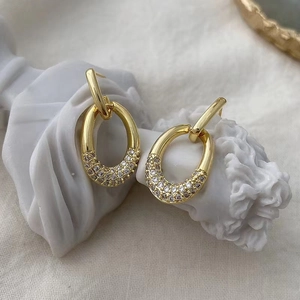 Detail of elegant gold oval drop earrings with shimmering micro-pave zircon crystals