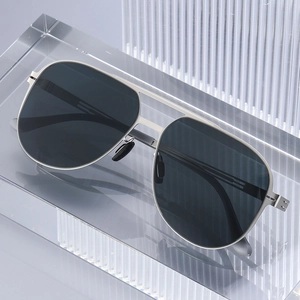 Classic silver pilot sunglasses with polarized dark grey lenses on a modern clear stand