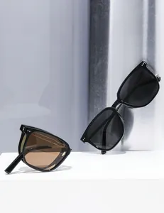 Detail of portable folding polarized sunglasses with classic black frames and rivet accents