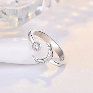 Detail of silver crescent moon and star ring with sparkling cubic zirconia stones