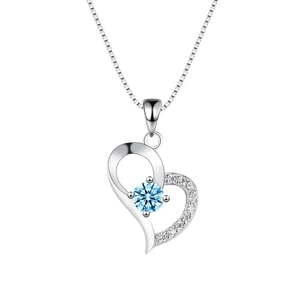 Dettaglio di un'elegante collana in argento a cuore con zircone blu centrale