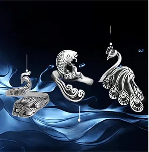 Detail of adjustable peacock, dragon fish, and phoenix rings for knitting and crochet