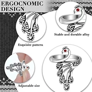 Detailed macro of vintage adjustable peacock knitting ring with red stone and feather texture