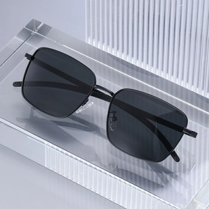 Classic black square polarized sunglasses with matte frames on a clear display stand