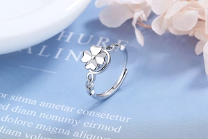 Detail view of silver adjustable clover ring with polished four-leaf clover motif