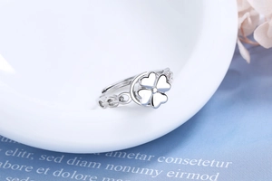 Detail view of silver adjustable ring featuring a rotatable four-leaf clover heart design