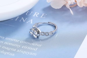 Detail view of silver rotating four-leaf clover ring with adjustable open band