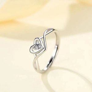 Detail of a silver open heart ring with a sparkling round-cut cubic zirconia stone