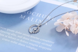 Macro detail of rotating sun and moon necklace pendant with sparkling zircon stones
