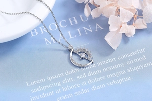 Macro shot of silver sun and moon pendant necklace with cubic zirconia on art paper
