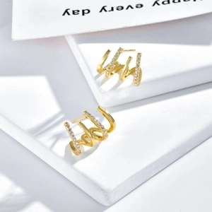 Modern s925 silver 18k gold plated spiral zircon stud earrings on white pedestal