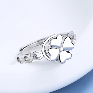 Silver rotating four-leaf clover ring with hollow chain band on white background