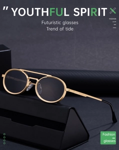 Detail of round gold metal sunglasses with dark grey lenses and a black leather case