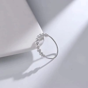 Detail shot of silver anti-anxiety ring featuring movable frosted beads on polished band