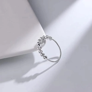 Minimalist silver fidget ring with movable spiral textured beads for anxiety relief