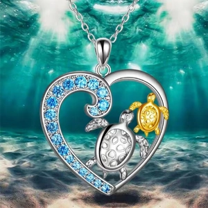 Ocean-themed heart turtle necklace with blue zircons on a scenic seabed background