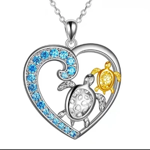 Ocean heart pendant necklace with silver frame, blue stones and golden turtle motifs
